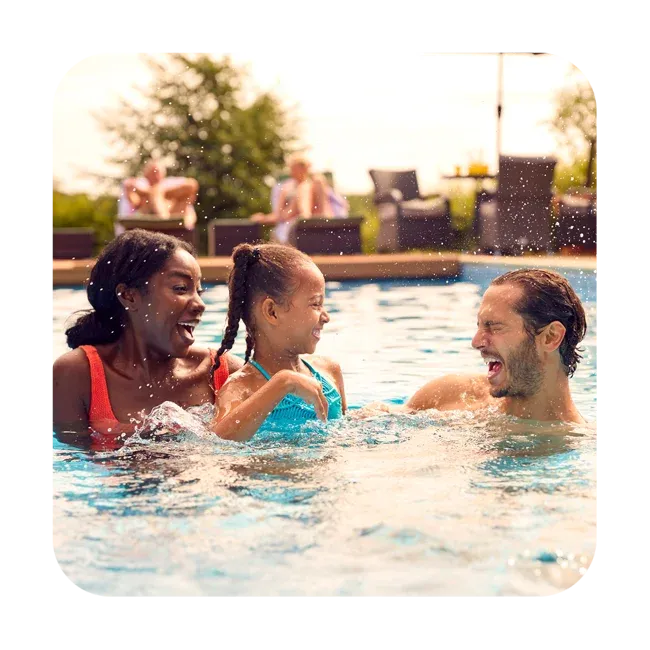 family swimming and having fun in pool